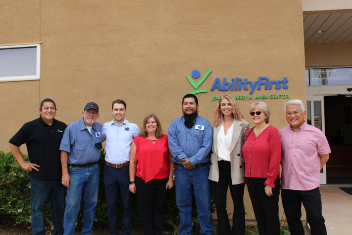 Maintco Corp's Alan Radojcic and Inna Tuler posing for a photo with AbilityFirst's team